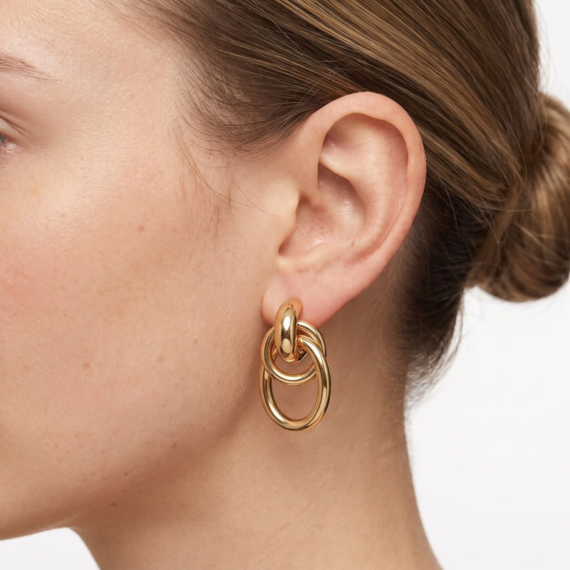 Close-up of the Lelice Sasha Interlocking Link Earrings in gold on the ear
