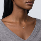 Woman turned three-quarters wearing the Seraphina Opal Necklace