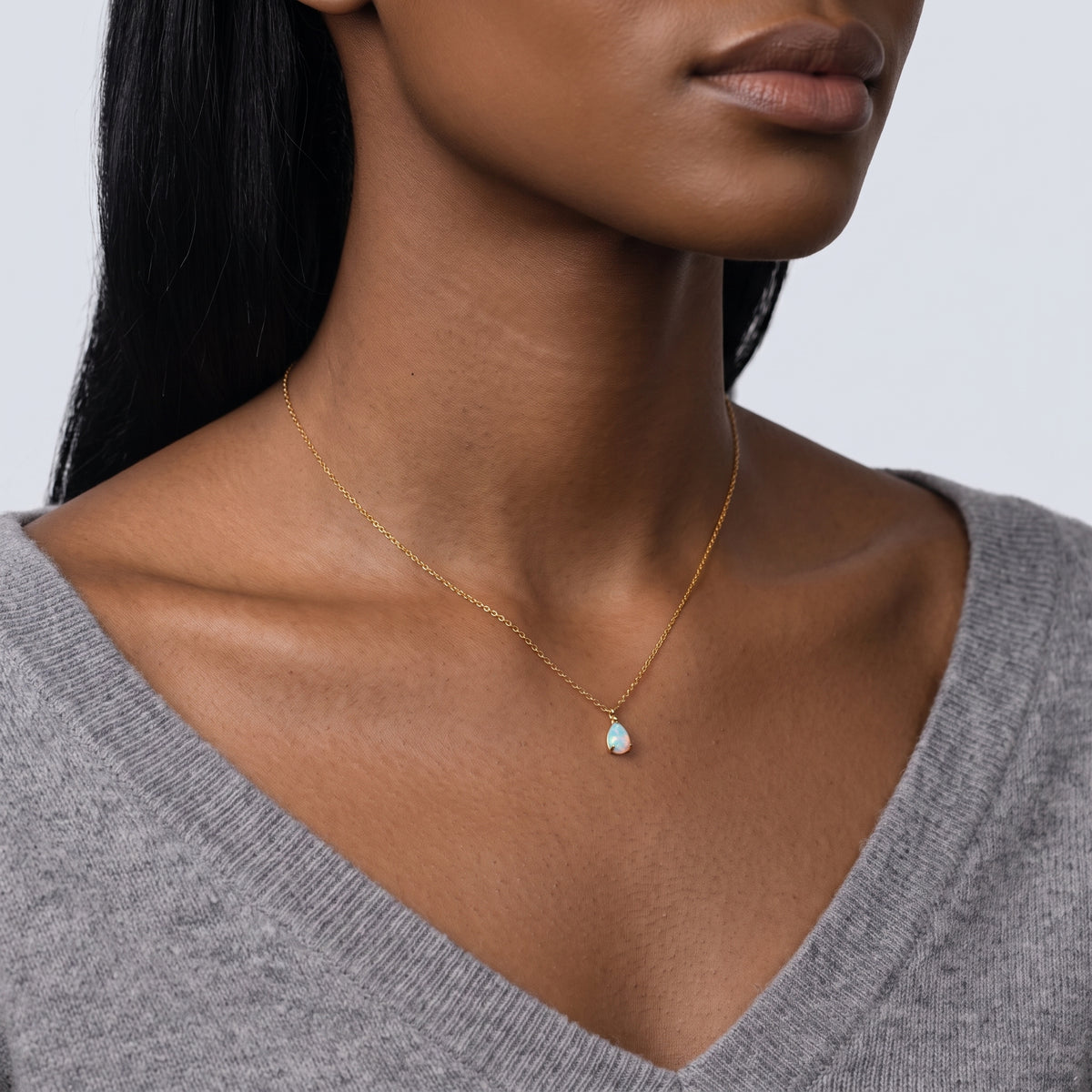 Woman turned three-quarters wearing the Seraphina Opal Necklace