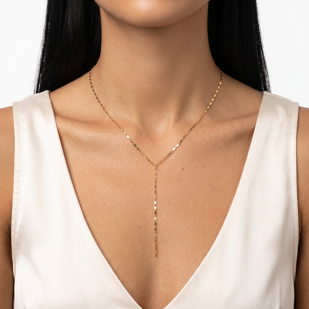 Close-up of the Lelice Shimmer Lariat Necklace in gold at the collarbone