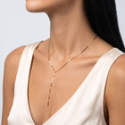 Three-quarter profile of a woman wearing the Shimmer Lariat Necklace