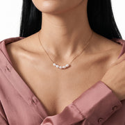 Close-up of the Lelice Siena Pearl Necklace in gold at the collarbone