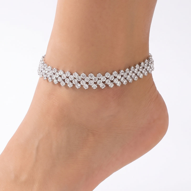 Close-up of the Lelice Silver Riviera Anklet on a woman's ankle