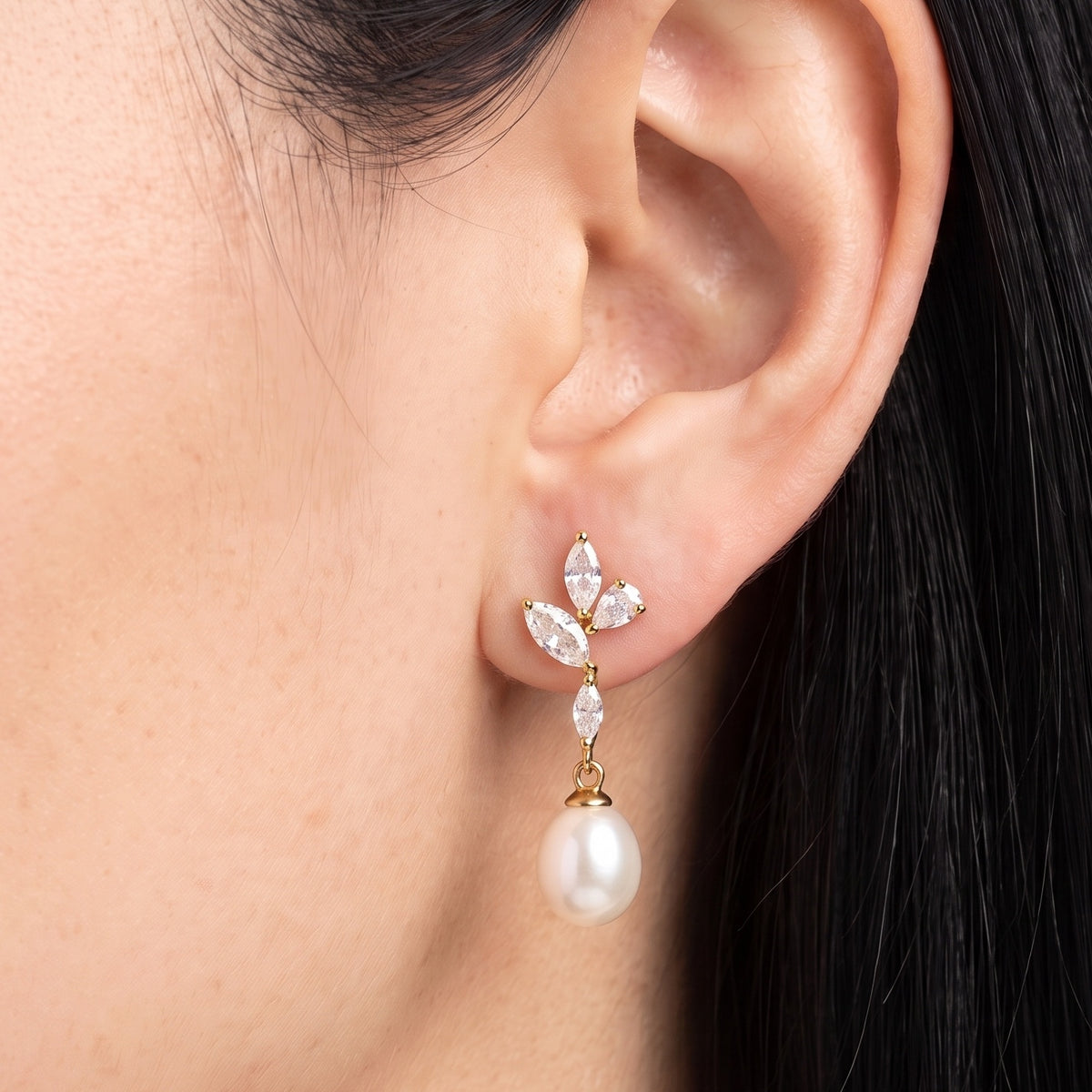 Close-up of the Lelice Simone Baroque Earrings in gold on the ear