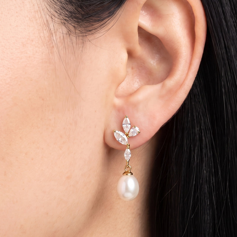 Close-up of the Lelice Simone Baroque Earrings in gold on the ear