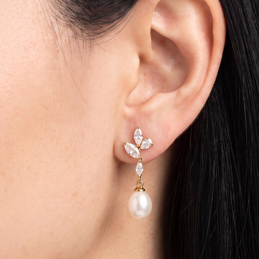 Close-up of the Lelice Simone Baroque Earrings in gold on the ear