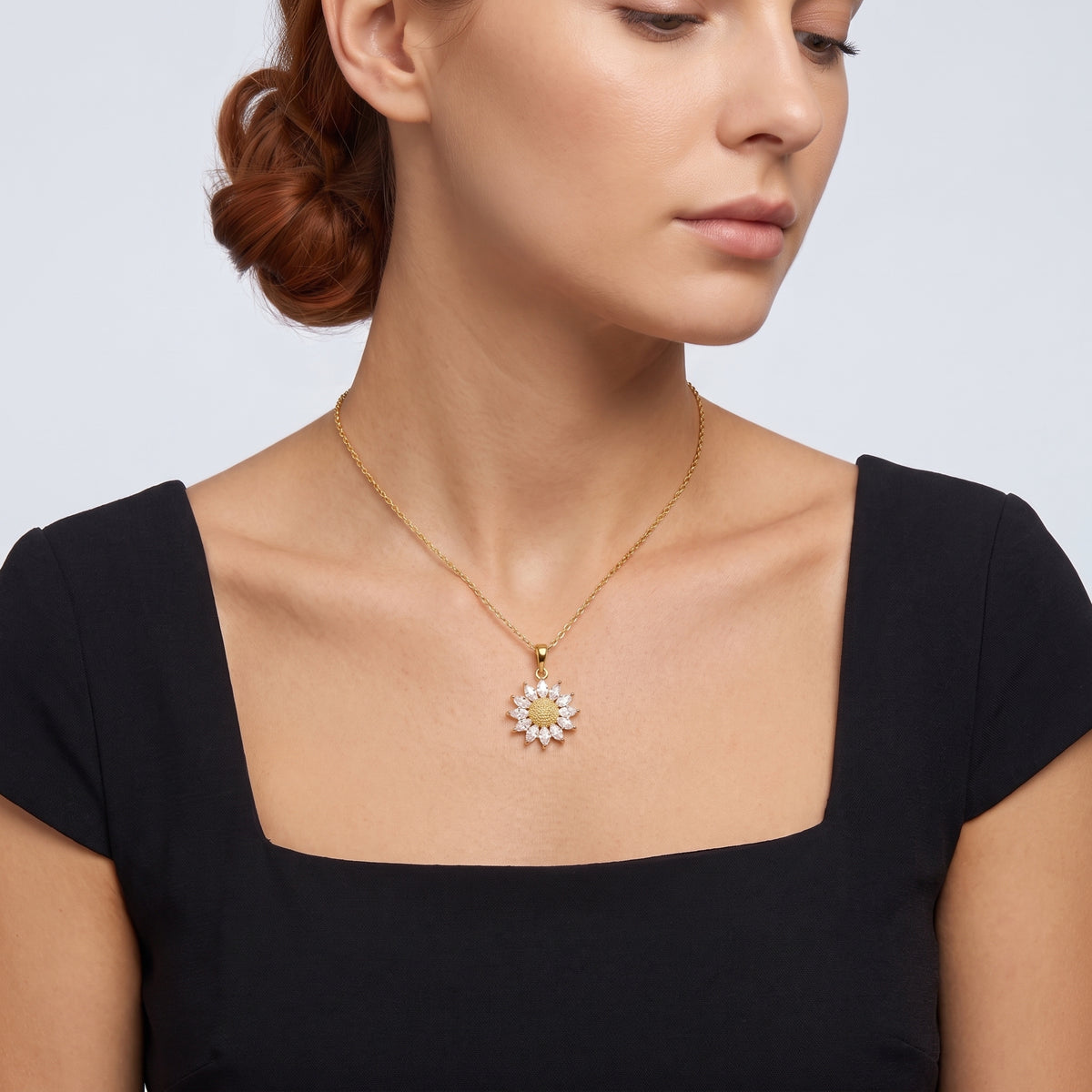 Neckline profile with hair up, wearing the Soleil Gold Sunflower Pendant Necklace