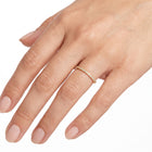 Hand wearing Lelice gold crystal pavé band ring Solène