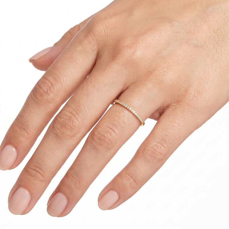 Hand wearing Lelice gold crystal pavé band ring Solène