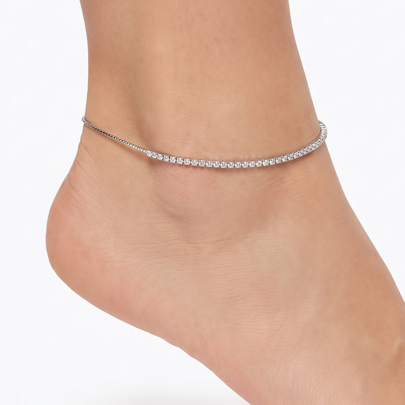 Close-up of the Lelice Solène Glow Anklet in silver on a woman's ankle