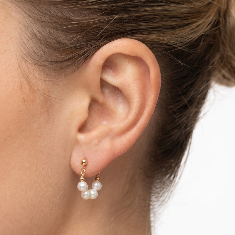 Close-up of the Lelice Sophie Pearl Hoops in gold on the ear