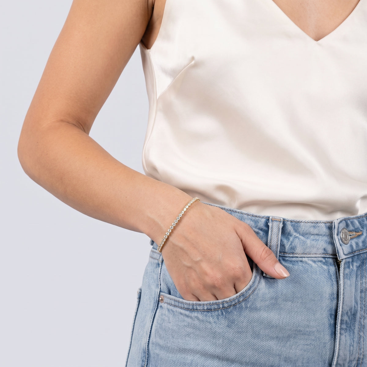 Model wearing the Lelice Sophie Tennis Bracelet in gold, hand in the jeans pocket