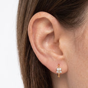 Close-up of the Lelice Sparkle Gold Hoops on the ear