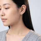Model wearing the Lelice Sparkle Silver Hoops, turned toward the light
