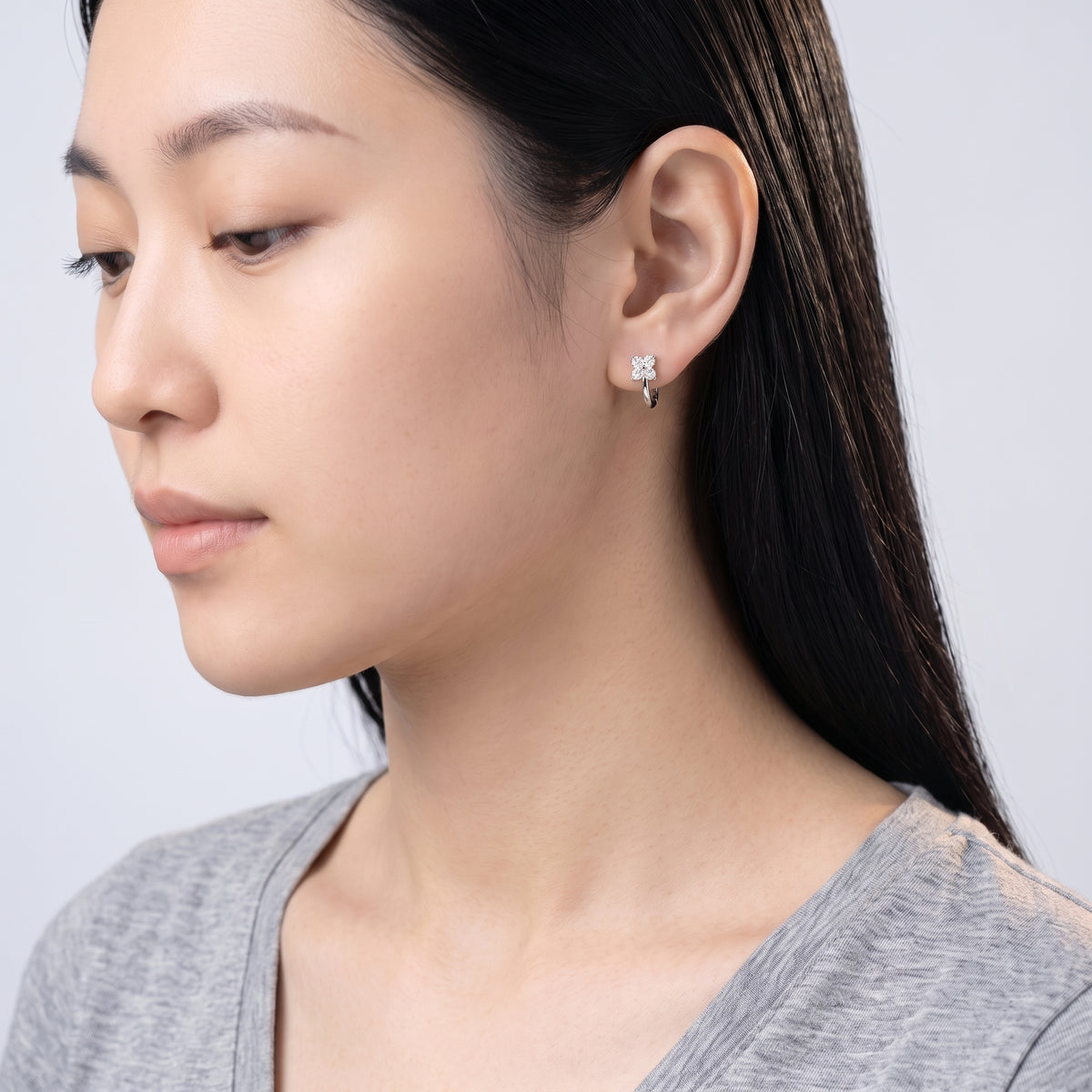 Model wearing the Lelice Sparkle Silver Hoops, downcast beauty portrait