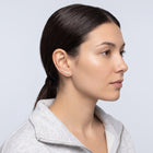 Model wearing the Lelice Stella Gold Flower and Star Crystal Ear Climbers, slicked-back profile