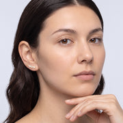 Model wearing the Lelice Stella Gold Flower and Star Crystal Ear Climbers, hand at the chin