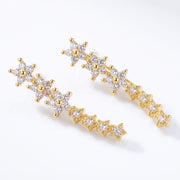 Lelice Stella Gold Flower and Star Crystal Ear Climbers on a white background