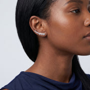 Model wearing the Lelice Stella Silver Flower and Star Crystal Ear Climbers, ear and jaw, slightly wider