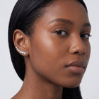 Model wearing the Lelice Stella Silver Flower and Star Crystal Ear Climbers, three-quarter face close-up