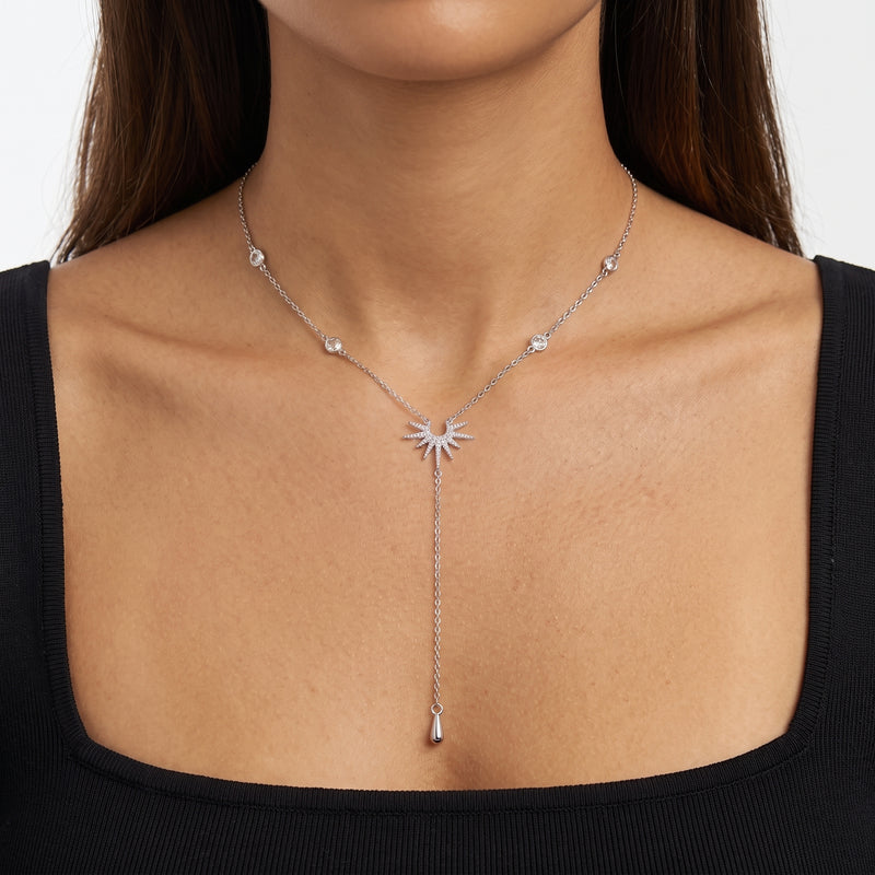 Close-up of the Lelice Sunburst Lariat Silver Necklace at the collarbone