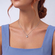 Low-angle portrait of a woman wearing the Sylvie Silver Necklace