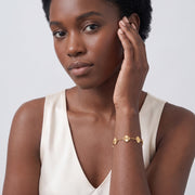 Model wearing the Lelice Tessa Gold Bracelet, hand at the face