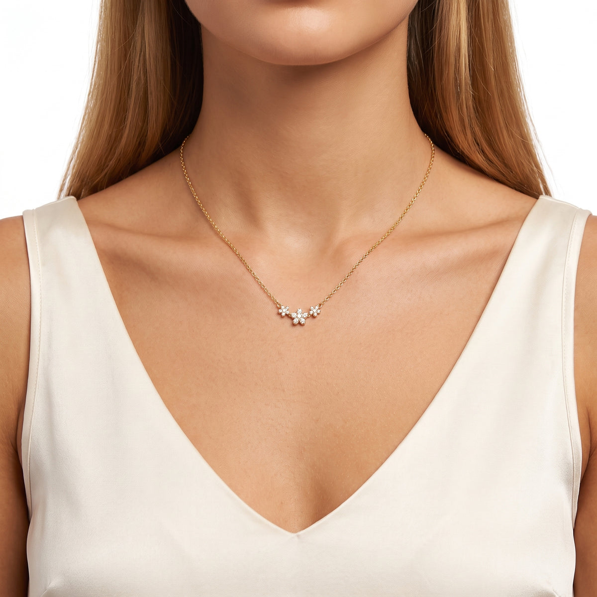 Close-up of the Lelice Blossom Trio Necklace in gold at the collarbone