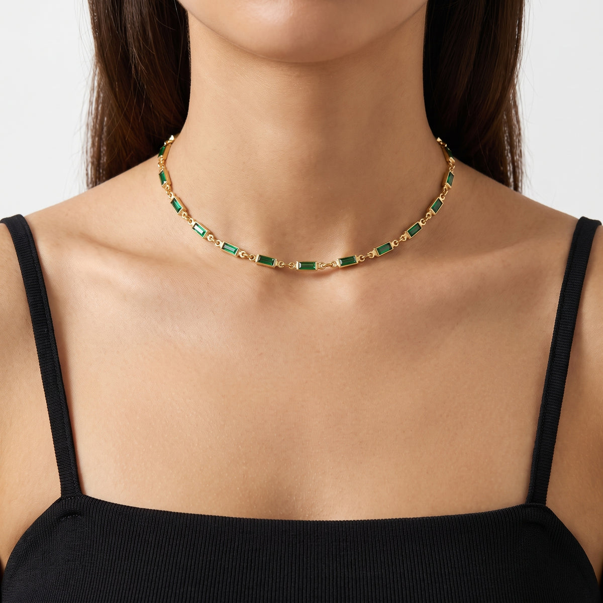 Close-up of the Lelice Deco Emerald Choker in gold at the collarbone