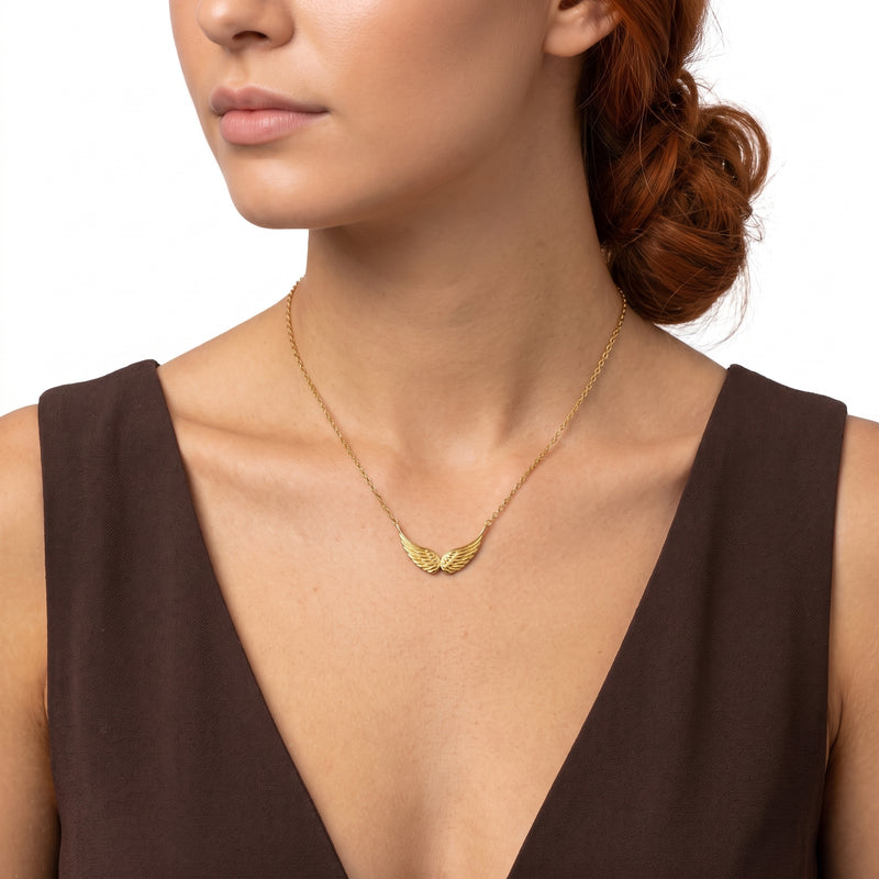 Close-up of the Lelice Guardian Wings Necklace in gold at the collarbone