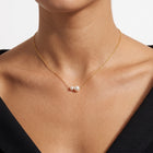 Close-up of the Lelice Pearl Duet Necklace in gold at the collarbone