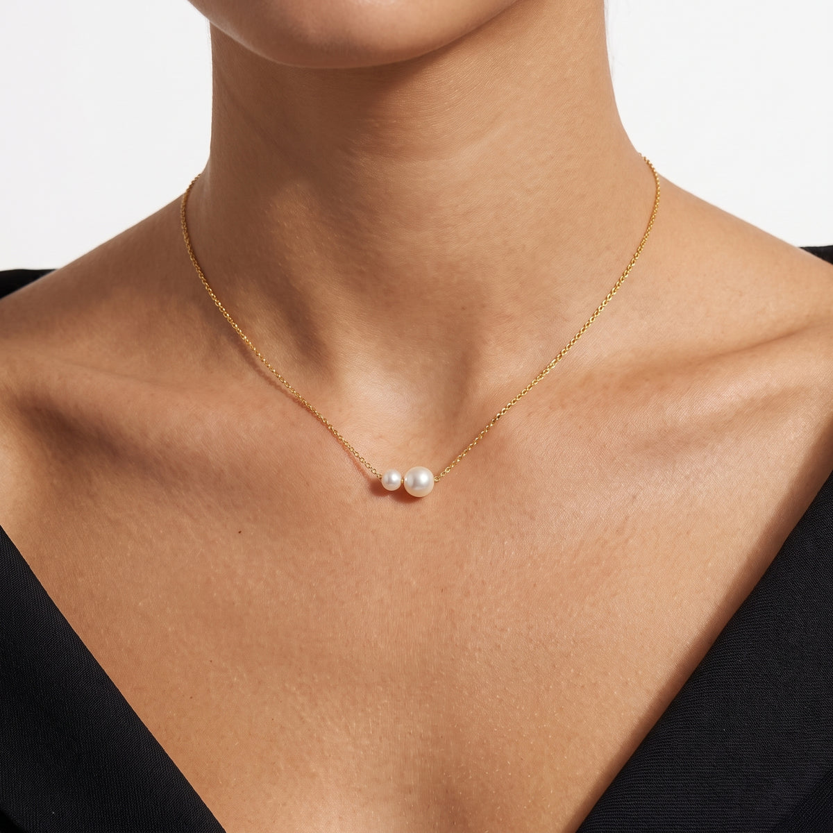 Close-up of the Lelice Pearl Duet Necklace in gold at the collarbone