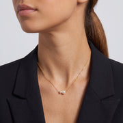 Side profile of the neckline with the Pearl Duet Necklace
