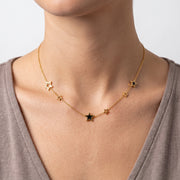 Close-up of the Lelice Stardust Choker in gold at the collarbone