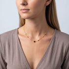 Shoulders and neckline of a woman wearing the Stardust Choker