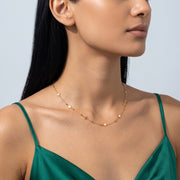 Three-quarter profile of a woman wearing the Stardust Trail Necklace