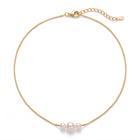 Lelice Trinity Pearl Necklace in gold on a white background