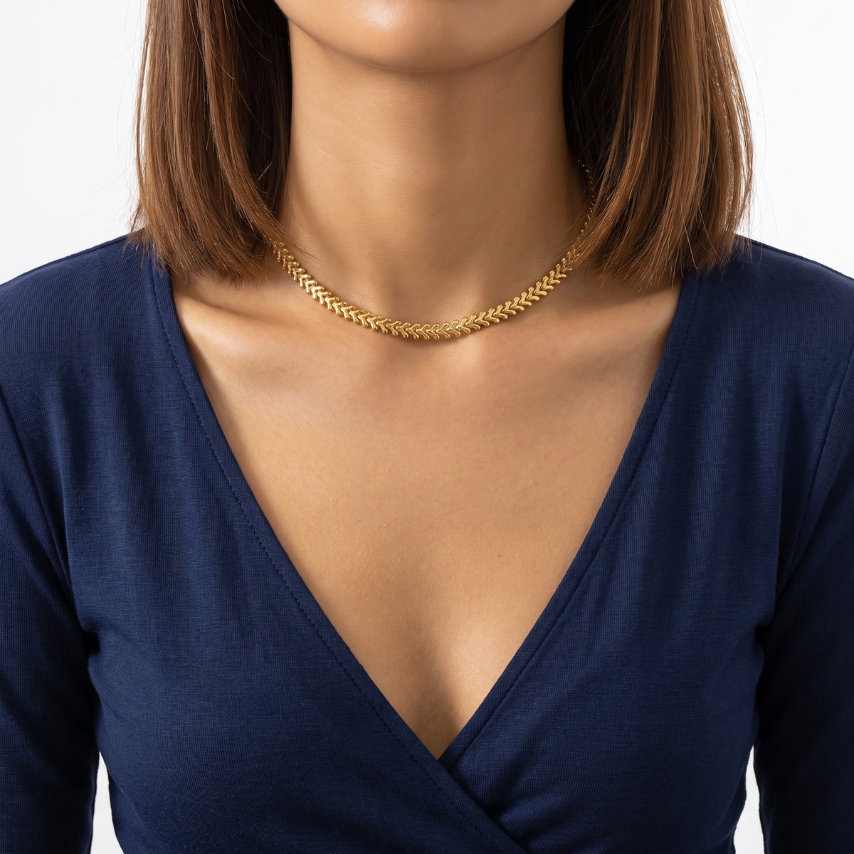 Close-up of the Lelice V-Link Choker in gold at the collarbone