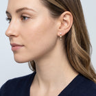 Model wearing the Lelice Trinity Pearl Drops in gold, side profile portrait