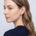 Model wearing the Lelice Trinity Pearl Drops in gold, three-quarter back view