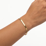 Close-up of the Lelice Vera Coil Bracelet in gold on the wrist