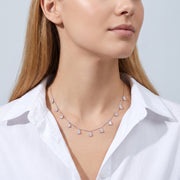Woman in soft side light wearing the Vivienne Drop Necklace