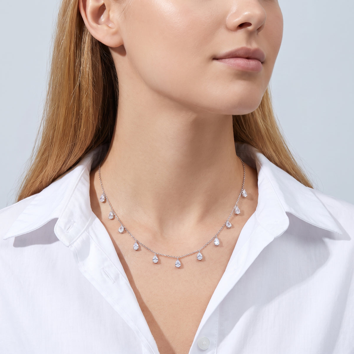 Woman in soft side light wearing the Vivienne Drop Necklace