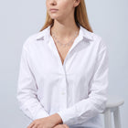 Seated woman wearing the Vivienne Drop Necklace