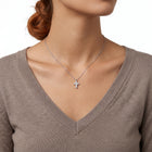 Close-up of the Lelice Zara Cross Necklace in silver at the collarbone