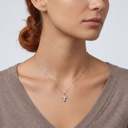 Neckline profile with hair up, wearing the Zara Cross Necklace