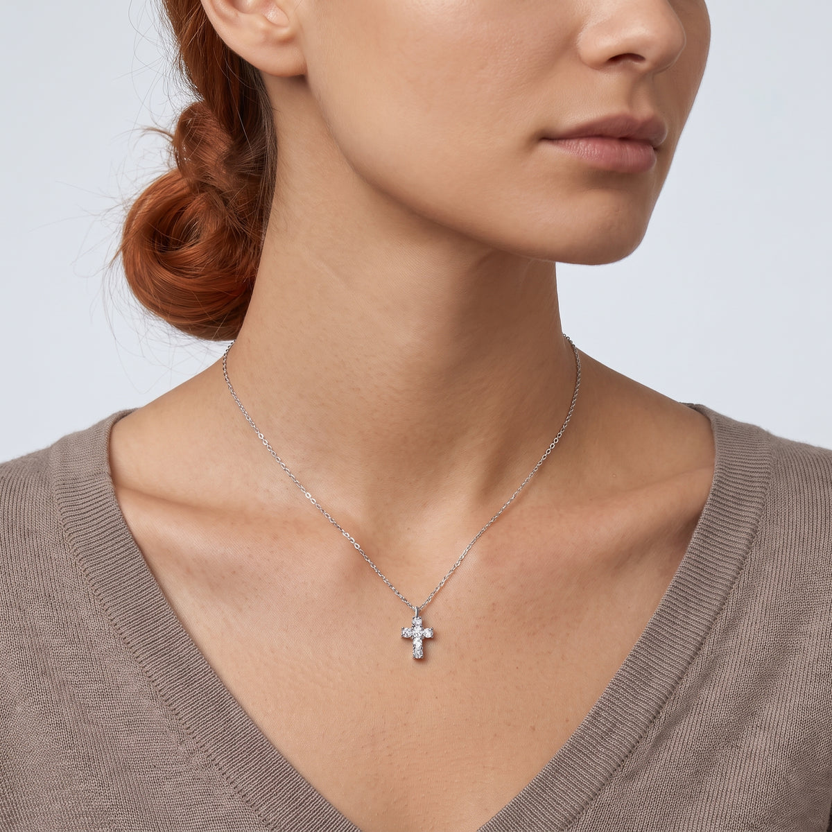 Neckline profile with hair up, wearing the Zara Cross Necklace