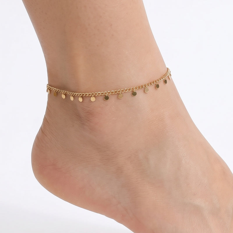 Close-up of the Lelice Zoe Charm Anklet in gold on a woman's ankle