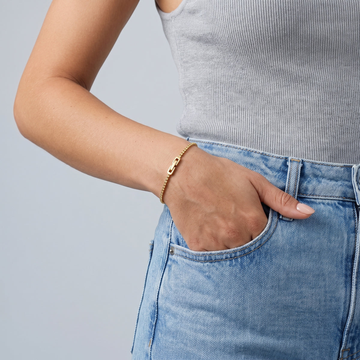Model wearing the Lelice Zoé Peridot Bracelet in gold, hand in the jeans pocket